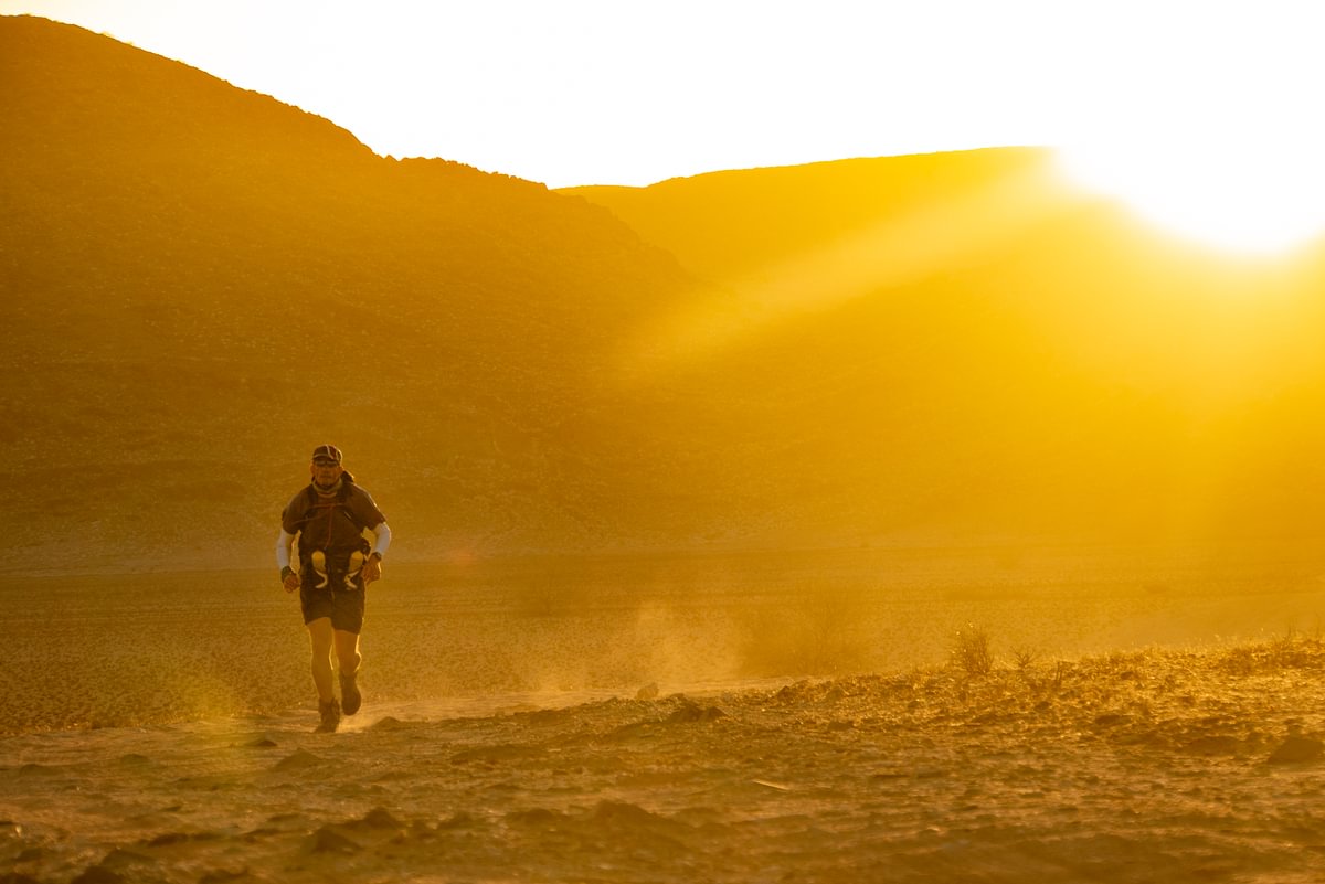 A runner racing through the Namib Desert during the BTU Desert Ultra